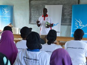 Generations For Peace volunteer speaking to participants inside a classroom