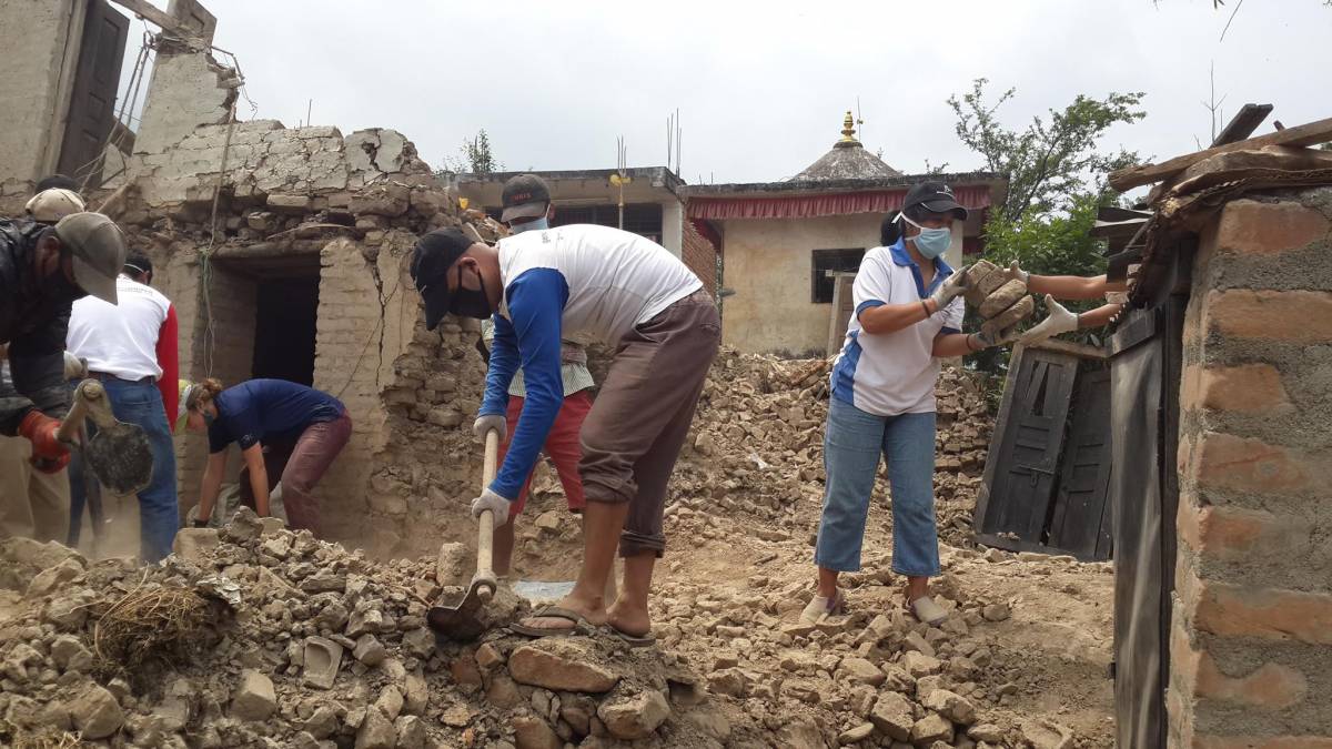 Generations For Peace volunteers working on a house destroyed by the earthquake in Nepal